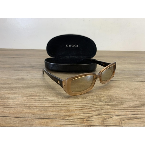 936 - A pair of vintage women's sunglasses in Gucci case