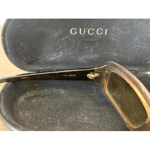 936 - A pair of vintage women's sunglasses in Gucci case