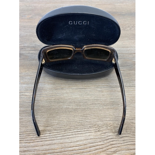 936 - A pair of vintage women's sunglasses in Gucci case