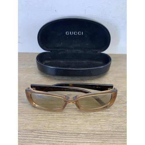 936 - A pair of vintage women's sunglasses in Gucci case