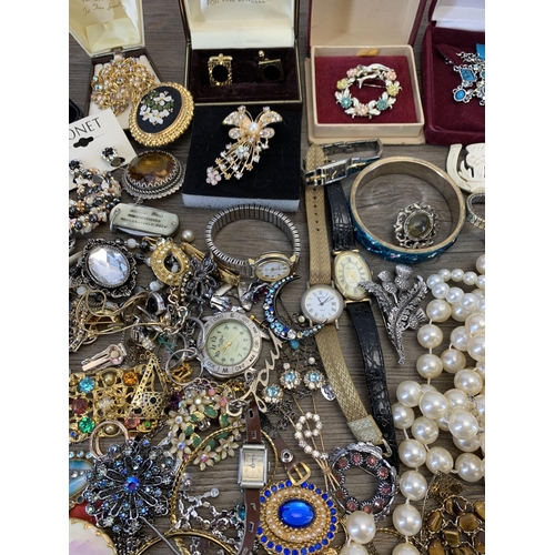 945 - A collection of vintage costume jewellery and wristwatches to include brooches, blue enamel and whit... 