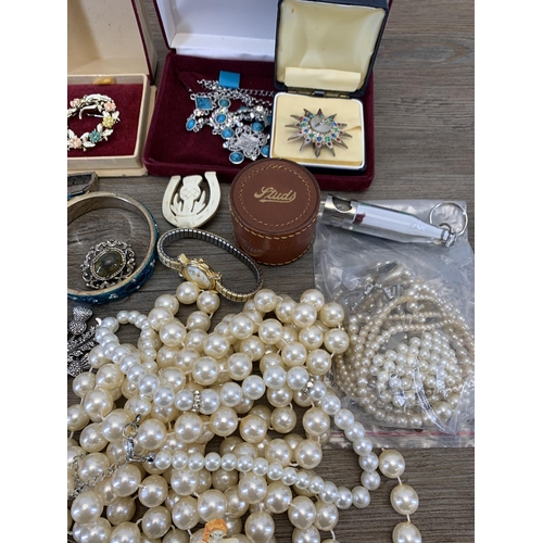 945 - A collection of vintage costume jewellery and wristwatches to include brooches, blue enamel and whit... 