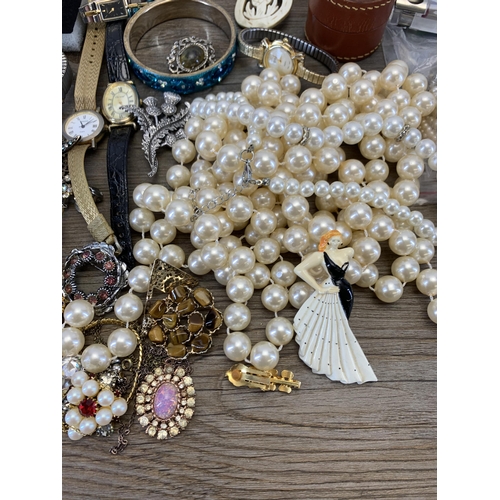 945 - A collection of vintage costume jewellery and wristwatches to include brooches, blue enamel and whit... 