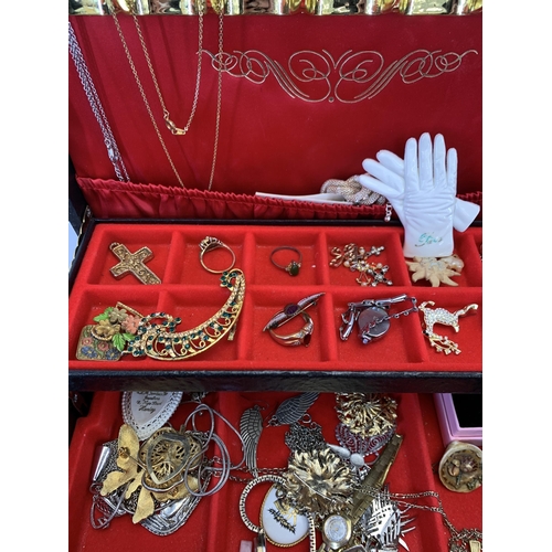 965 - A vintage jewellery box containing a collection of costume jewellery and wristwatches to include yel... 