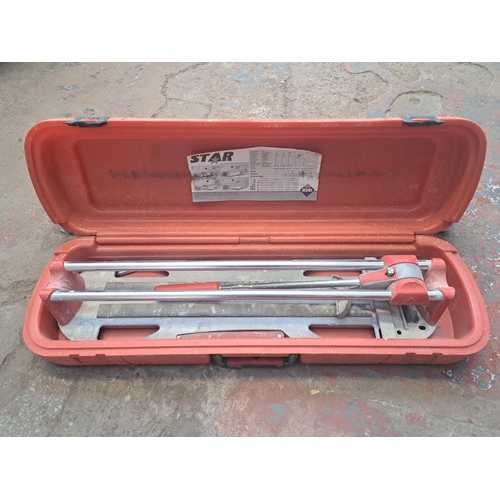 1220 - Two items, one boxed Badabulle baby gate and one cased Star-40-N Plus tile cutter