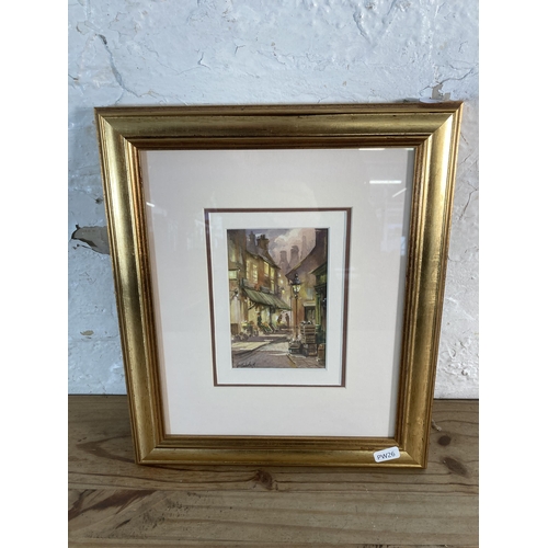 264 - A gilt framed watercolour of a street scene signed lower left - approx. 36cm high x 30cm wide