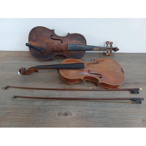 376 - Two unlabelled violins, one possibly baroque with tuning pegs and tailpiece (at fault - break at hee... 