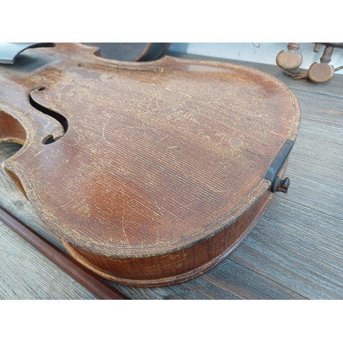 376 - Two unlabelled violins, one possibly baroque with tuning pegs and tailpiece (at fault - break at hee... 