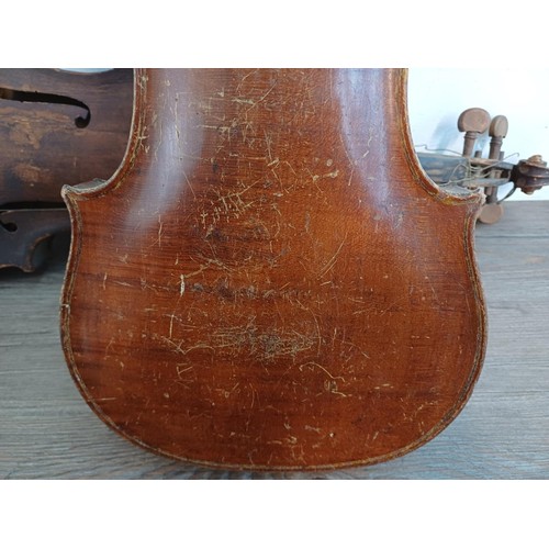 376 - Two unlabelled violins, one possibly baroque with tuning pegs and tailpiece (at fault - break at hee... 