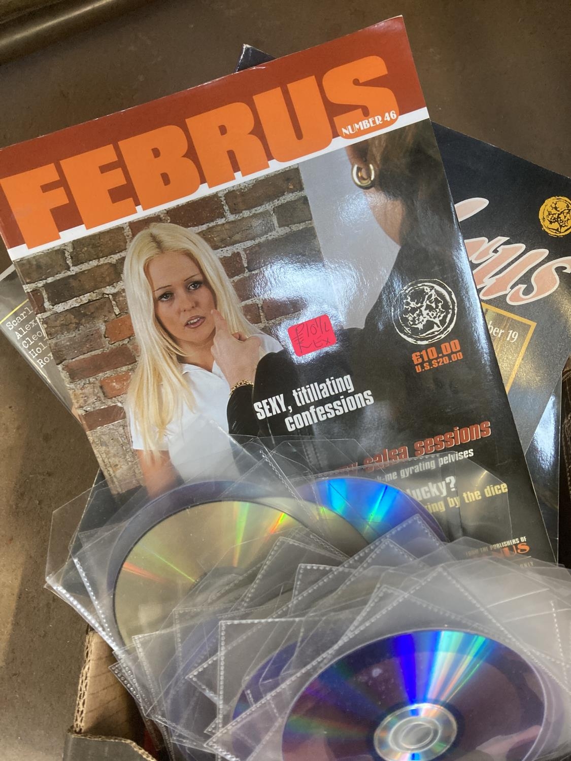 A box containing pornographic DVDs and magazines to include Februs etc.