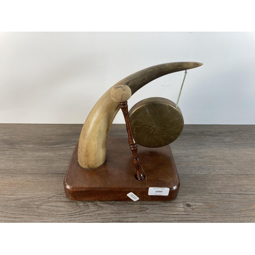 1099 - A vintage horn and brass dinner gong on mahogany base - approx. 27cm high