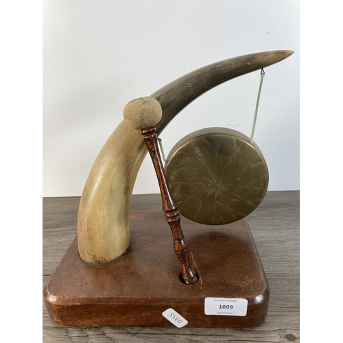 1099 - A vintage horn and brass dinner gong on mahogany base - approx. 27cm high