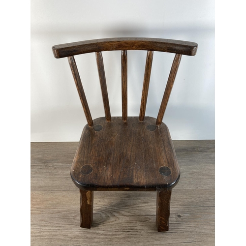 1101 - A vintage oak stick back doll's chair - approx. 41cm high x 23cm wide