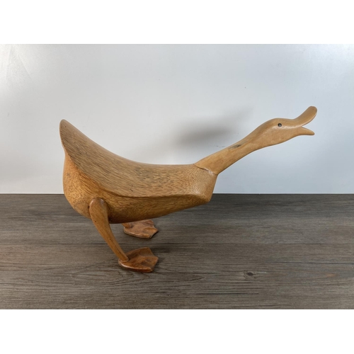 1105 - A contemporary carved wooden duck figurine - approx. 25cm high x 44cm long