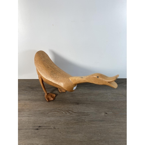 1105 - A contemporary carved wooden duck figurine - approx. 25cm high x 44cm long