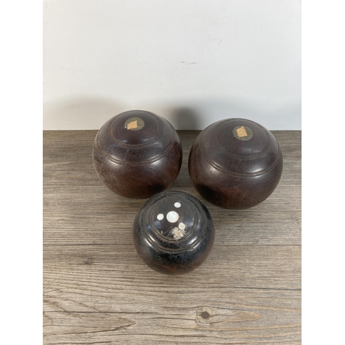 1106 - A pair of early 20th century Taylor Lignum Vitae crown green bowls