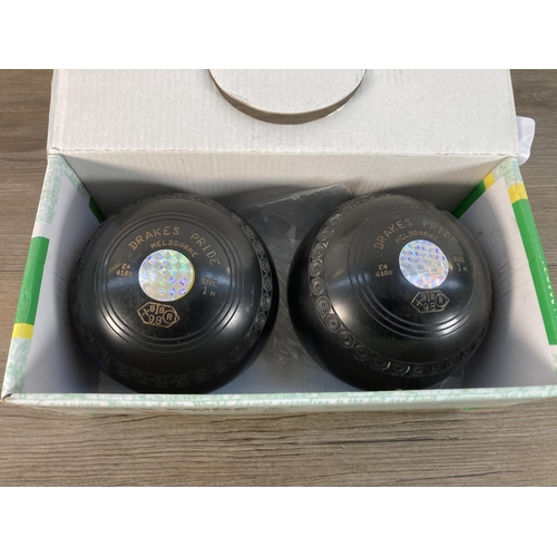 1113 - A pair of boxed Drakes Pride crown green bowls