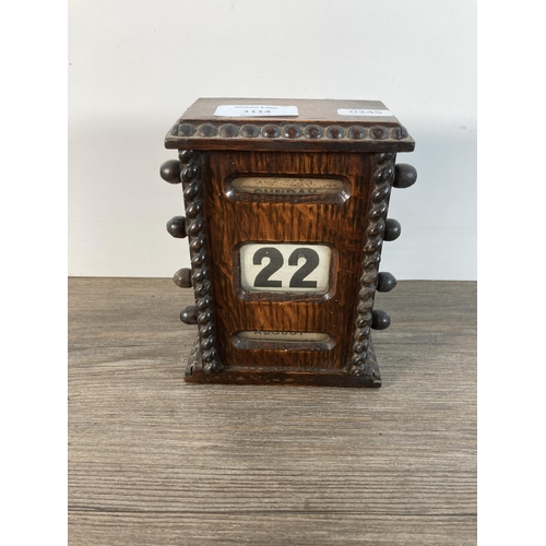 1114 - An early/mid 20th century oak perpetual desk calendar - approx. 16cm high x 11cm wide