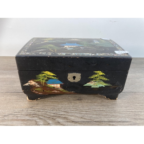 1115 - A early/mid 20th century Japan lacquer and hand painted musical jewellery box