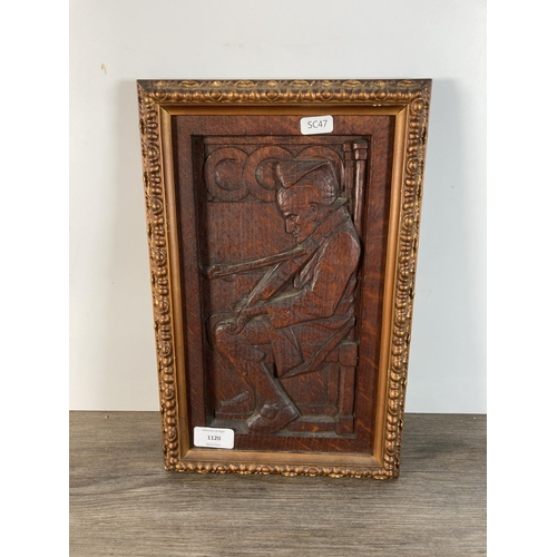 1120 - A carved oak panel of a fiddle player in gilt frame - approx. 35cm high x 23cm wide