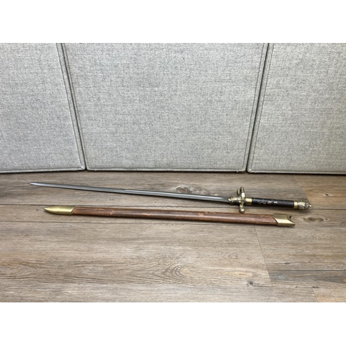 1126 - An ornamental brass and steel sword with leatherette scabbard - approx. 102cm long