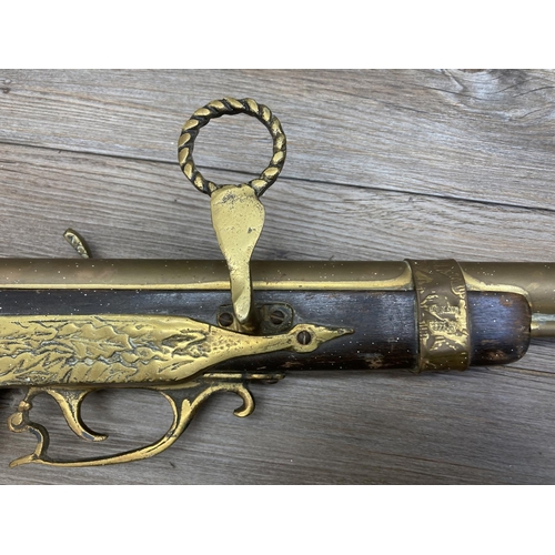 1136 - A vintage brass and hardwood ornamental wall hanging rifle - approx. 98cm long