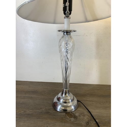 1042 - A pair of contemporary cut glass and chrome plated table lamps with white shades - approx. 73cm high... 