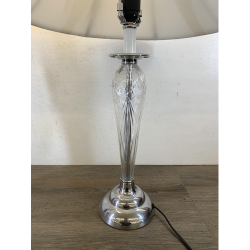 1042 - A pair of contemporary cut glass and chrome plated table lamps with white shades - approx. 73cm high... 