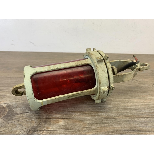 1043 - A mid 20th century cast metal and red glass naval port beacon lamp - approx. 32cm high