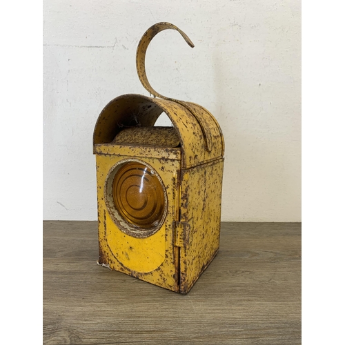 1061 - A vintage paraffin yellow painted road lantern - approx. 37cm high