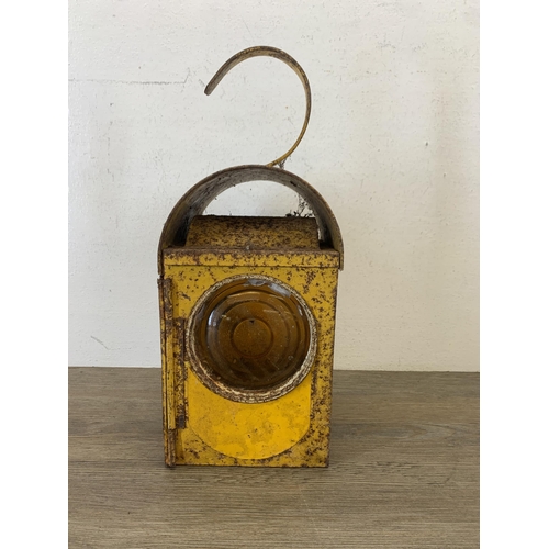 1061 - A vintage paraffin yellow painted road lantern - approx. 37cm high