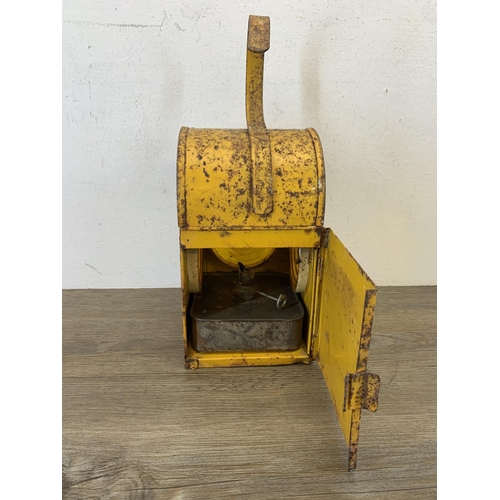 1061 - A vintage paraffin yellow painted road lantern - approx. 37cm high