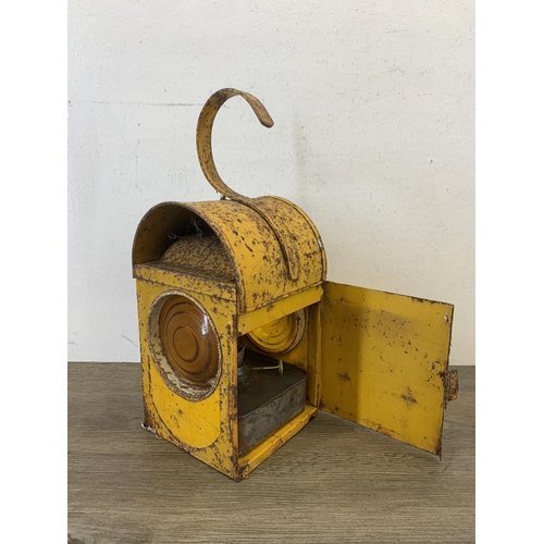 1061 - A vintage paraffin yellow painted road lantern - approx. 37cm high