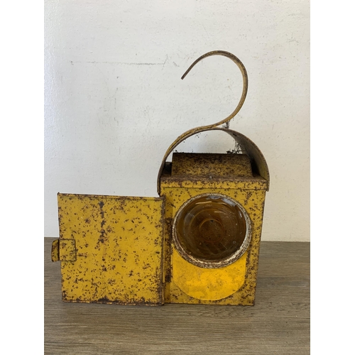 1061 - A vintage paraffin yellow painted road lantern - approx. 37cm high