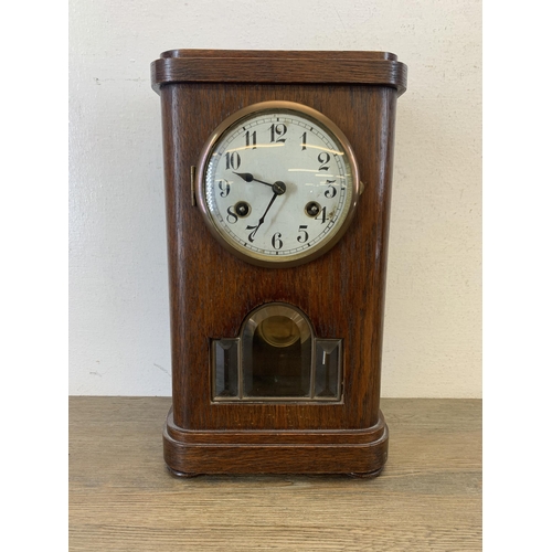 1074 - An early 20th century oak cased chiming mantel clock with Junghans movement - approx. 36cm high x 20... 