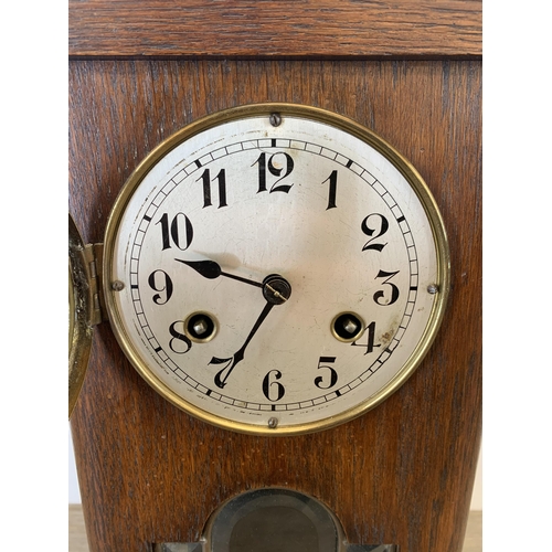 1074 - An early 20th century oak cased chiming mantel clock with Junghans movement - approx. 36cm high x 20... 