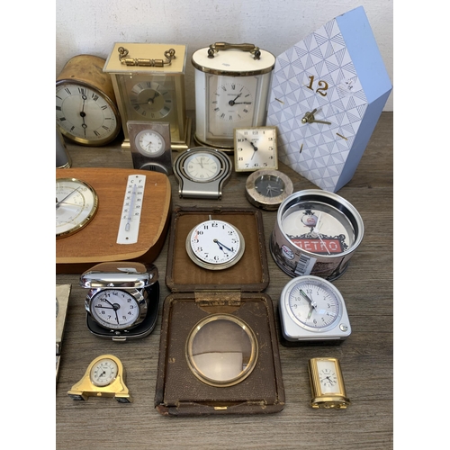 1077 - A large collection of bedside and alarm clocks to include mid 20th century Metamec carriage clock et... 