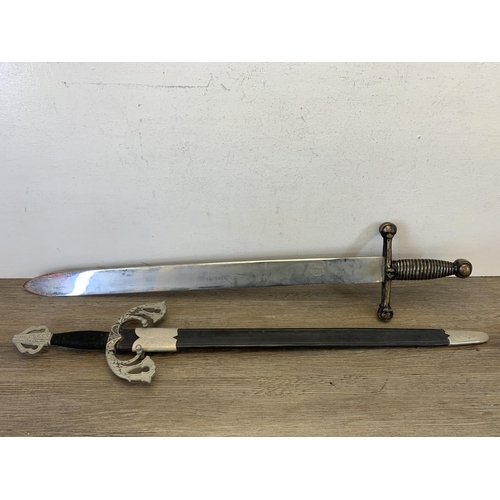 1081 - Two decorative ornamental swords - largest approx. 76cm long