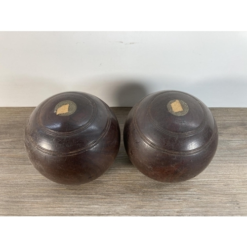 1106 - A pair of early 20th century Taylor Lignum Vitae crown green bowls