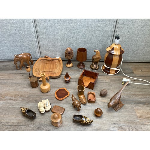 1140 - A collection of treenware to include carved teak goblet, table lamp, carved hardwood elephant figuri... 