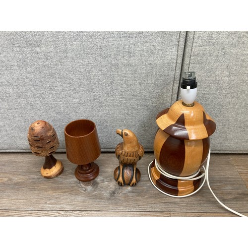 1140 - A collection of treenware to include carved teak goblet, table lamp, carved hardwood elephant figuri... 