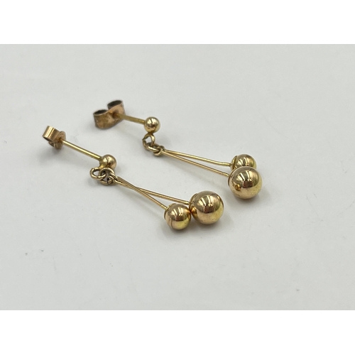 2333 - A pair of yellow metal earrings with 9ct gold backs - approx. gross weight 1.4g