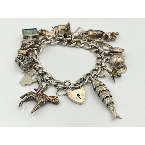 2334 - A hallmarked sterling silver charm bracelet with assorted silver charms - approx. gross weight 82g