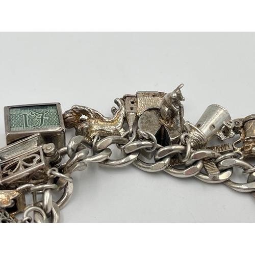 2334 - A hallmarked sterling silver charm bracelet with assorted silver charms - approx. gross weight 82g