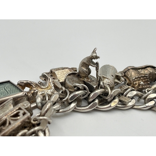 2334 - A hallmarked sterling silver charm bracelet with assorted silver charms - approx. gross weight 82g