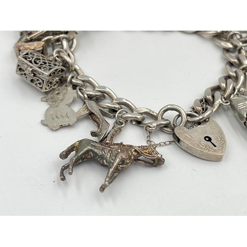 2334 - A hallmarked sterling silver charm bracelet with assorted silver charms - approx. gross weight 82g