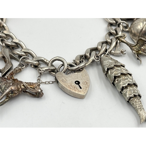 2334 - A hallmarked sterling silver charm bracelet with assorted silver charms - approx. gross weight 82g