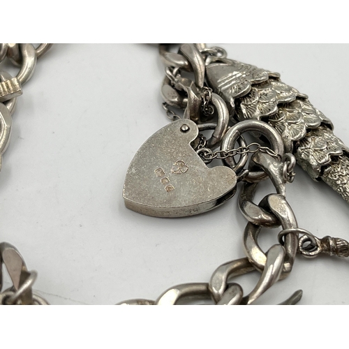 2334 - A hallmarked sterling silver charm bracelet with assorted silver charms - approx. gross weight 82g