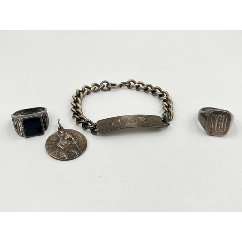 2335 - Four pieces of hallmarked sterling silver jewellery, two signet rings, one St. Christopher pendant a... 