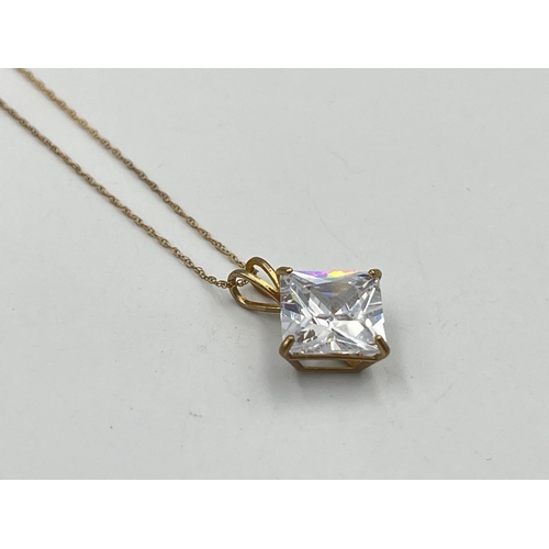 2357 - A 9ct gold cubic zirconia star burst pendant necklace with certificate of authenticity - approx. gro... 